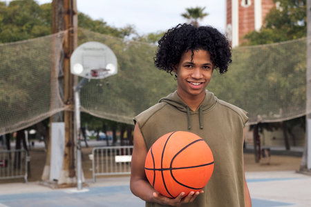 african american teen player with basket ballの写真素材