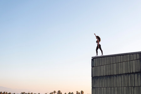 unrecognizable female athlete in building roofの写真素材