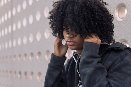 male teenager listening music in earphonesの写真素材