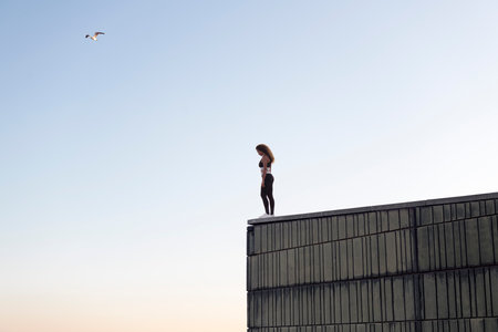 unrecognizable female athlete in building roofの写真素材