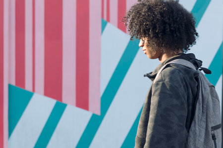 african american teenager walking on the streetの写真素材