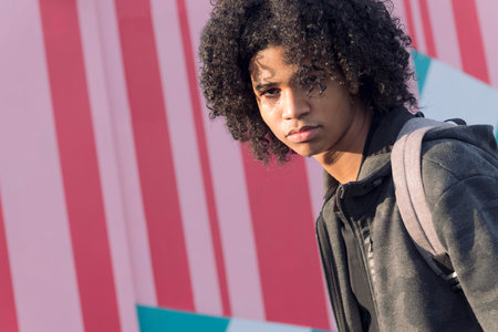 african american teenager walking on the streetの写真素材