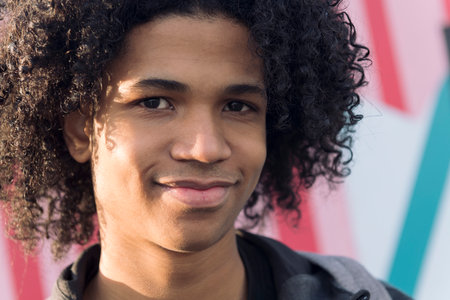 close up portrait of curly haired teenagerの写真素材