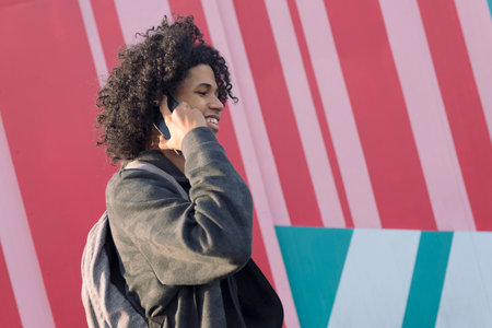 african american teenager talking on mobile phoneの写真素材