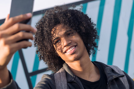 african american teenager taking selfie with phoneの写真素材