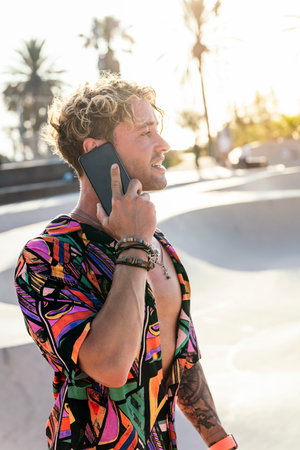 stylish millennial guy using mobile phoneの写真素材