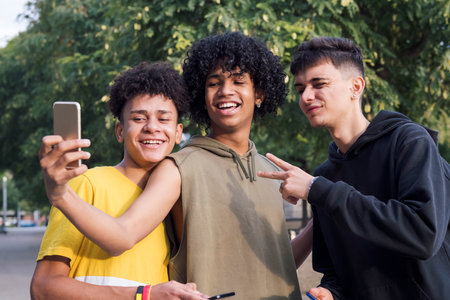 three male teens smiling happy taking selfie photoの写真素材