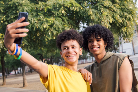 two male teens smiling happy taking selfie photoの写真素材