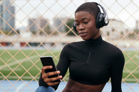 young female in headphones listening song on phone