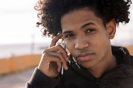 african american teenager talking on smart phone