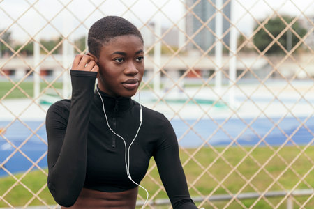 african american woman putting on earphones