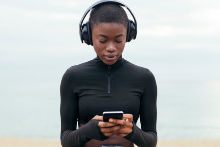woman listening music and using mobile phoneの写真素材