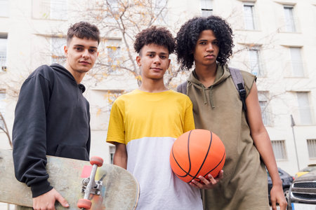 three teenager friends together looking at cameraの写真素材