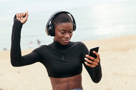 woman dancing while listening music in headphonesの写真素材