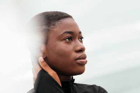 ethnic female with short hair touching faceの写真素材
