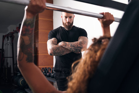 unrecognizable woman lifting barbell with weightの写真素材