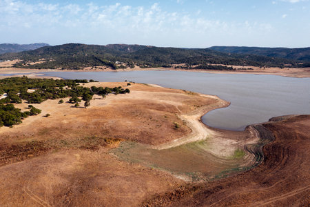 dry barren landscape with a lake in the distanceの写真素材