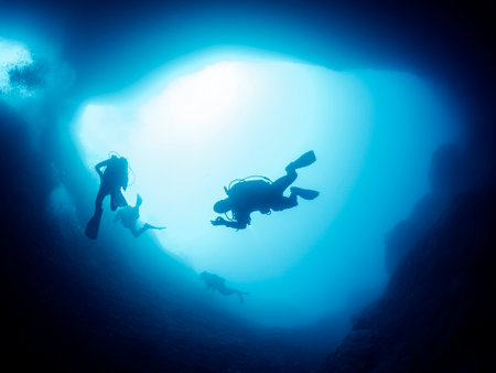 scuba diver doing ok symbol while diving in cave