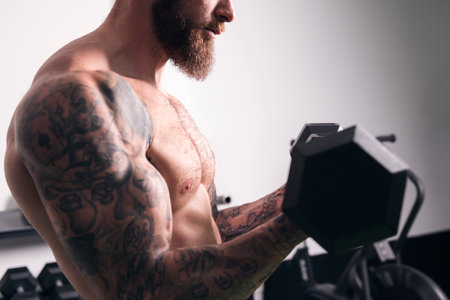 unrecognizable bodybuilder with heavy dumbbellsの写真素材