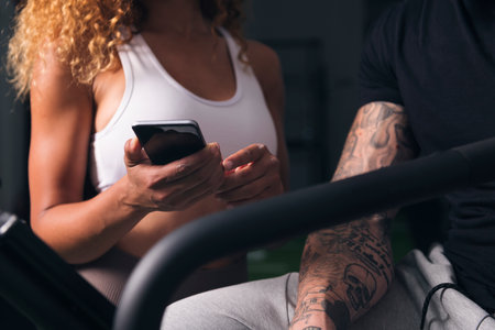 unrecognizable female showing smartphone to male