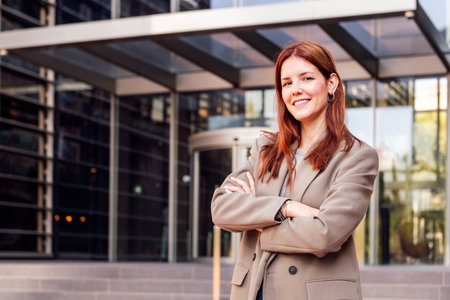 woman with arms crossed in front of officeの写真素材