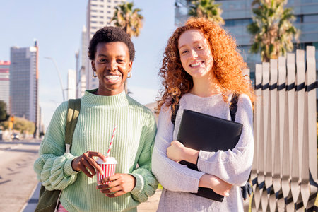 two young students smiling happy looking at cameraの写真素材