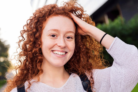 portrait of a happy young woman with curly hairの写真素材