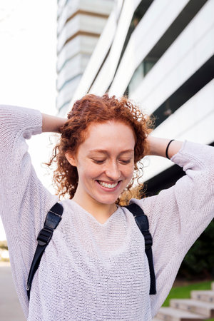 portrait of a happy young woman with curly hairの写真素材