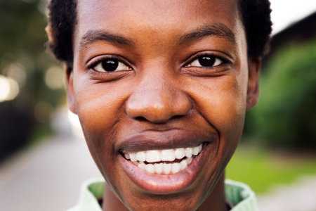 close up of a young black woman smiling happyの写真素材