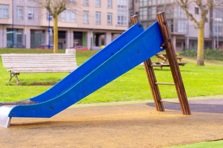 playground in which there is a slide worn by its useの写真素材