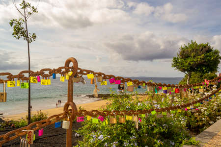 chain that delimits the beach where lovers take advantage to leave their love lockの写真素材