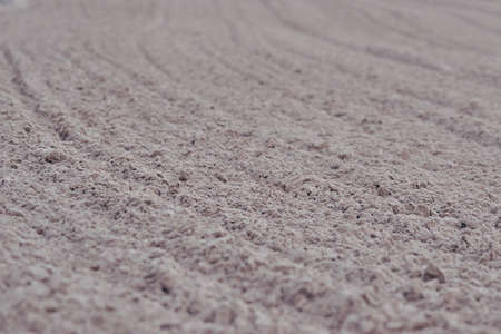 photography of beach sand, texture that reminds us of the infinite, the focused and unfocused, the grains of sand that end up being infamous in front of the beach, the lines make us travel with our eyes the photography from one extreme to anotherの写真素材