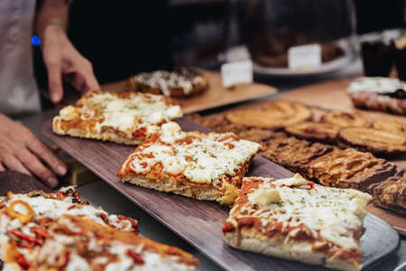 Pizza maker preparing cheese pizza table