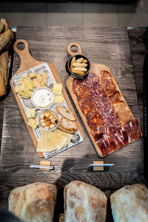 assortment of sausages and cheeses served on a wood plank