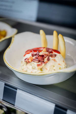 Spanish potato salad exposed on a restaurantの写真素材