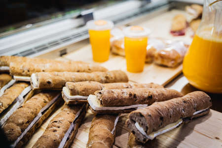 cheese sandwiches and orange juices exposed in a restaurantの写真素材