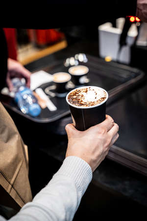 Cup of coffee held by a handの写真素材