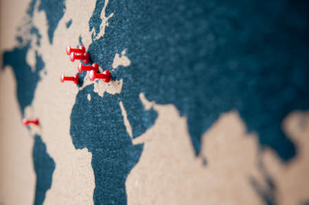 Atlas of Europe and continents with red pins for traveling or point destinations. With pinned...