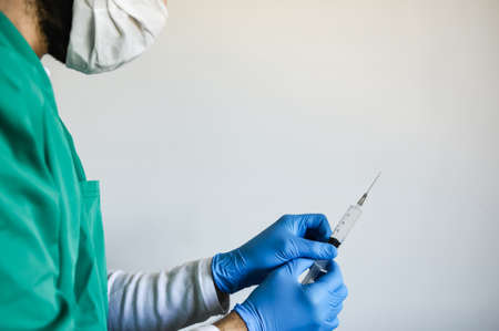 hand of a nurse or doctor holds a syringe which contains   vaccineの写真素材