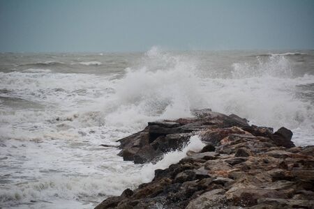 The breaking of the waves on the beach. Storm colors