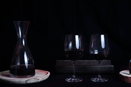 Wine glasses with bottle and pourer. Two wine glasses with wine utensils for the bottle, bottle and decorationsの写真素材