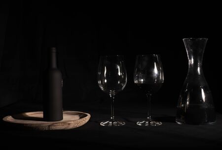 Wine glasses with bottle and pourer. Two wine glasses with wine utensils for the bottle, decorations, Blackの写真素材