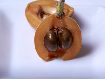 Medlar, split in two halves, orange, white, natural, ecological, Macro photographyの写真素材