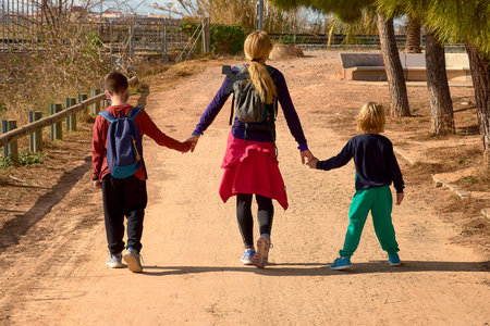 Blonde girl holding hands with two children. sport clothes, caucasian, blond, blonde, blonde,...