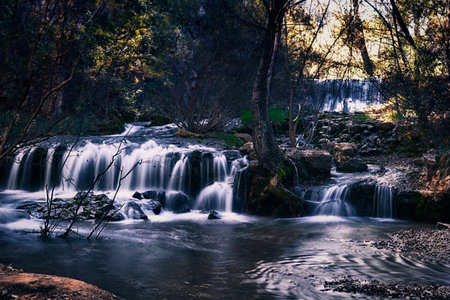 Cluster of small waterfalls in the autumn forest