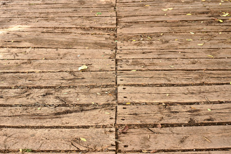 Old wooden planks with hole from a road