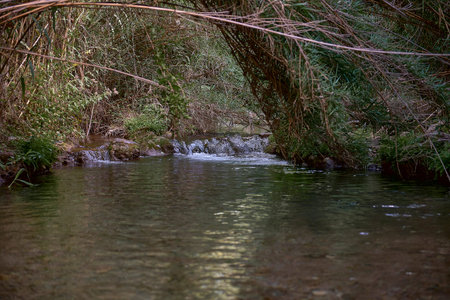 Small waterfall in a mountain river on a sunny day