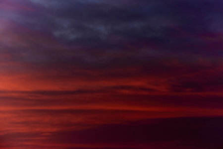 Sky light after sunset. orange background, cloudsの写真素材