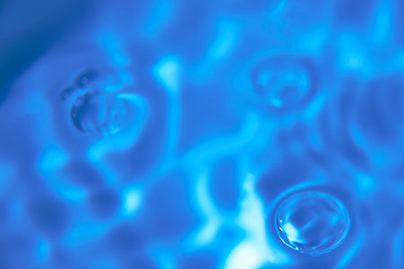 079.One or more drops of water splashing into waves and undefined shapes.Wallpaper.Concentric circles, madness, undefined shapes, waves, blue, green, magenta, cyan, metal, grayの写真素材