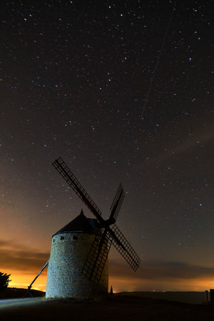 An old windmill in the night with cloudsの写真素材